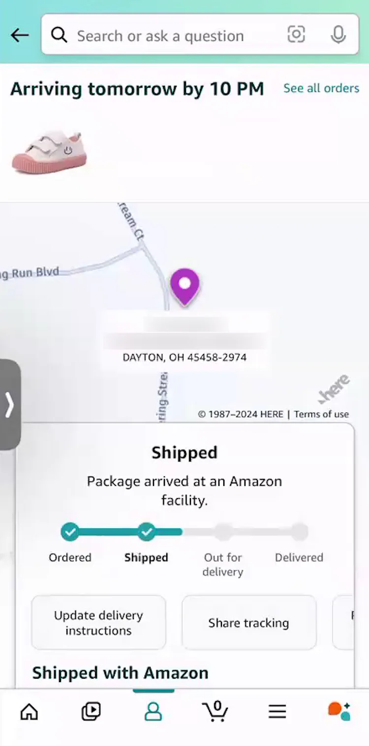 Mobile app “Order Tracking” page with order-tracking details and progress in a box on top of map view with pin.